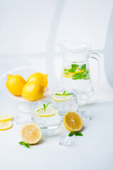 Lemon lemonade in the jar and glasses