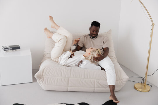 Interracial couple relaxing on sofa
