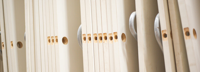 Panorama view metal safety racks support stack of hollow core interior doors with pre-drilled lockset holes at hardware store. Organized shelving for retail logistic and easy product access