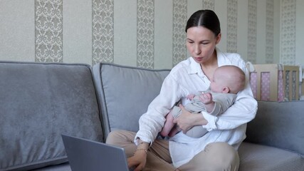 Mother balancing work and parenting with infant at home