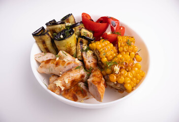 grilled vegeables and sasuage in the plate on white background