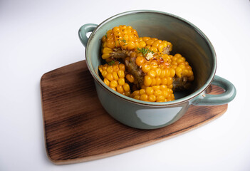 grilled corn chunks in a bowl on white background