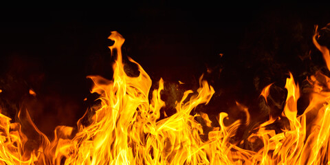 Dramatic red, orange, yellow flame and smoke rising against a dark background. Realistic, abstract...