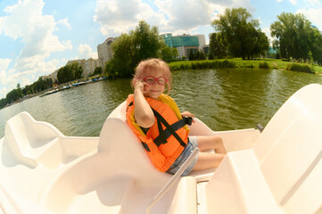 Girl enjoying paddle boat ride on city lake