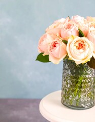 Fototapeta premium Delicate bouquet of pastel roses in a textured vase