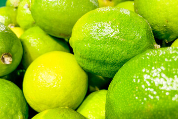 Limes in basket at grocery store, fruits and vegetables are sold at market