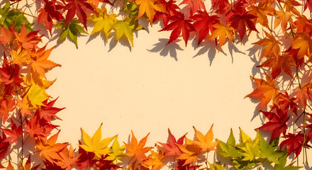 A creative seasonal layout with a rectangular frame made of vibrant autumn maple leaves in rich red, orange, and yellow hues, providing a natural border with copy space