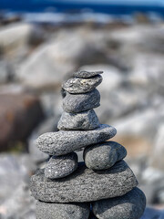Close-up of grey pebbles stacked at the Norwegian sea coast