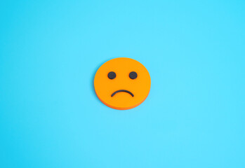 Sad face smiley orange. Disappointment and discontent. Anxiety and uncertainty, stress symbol, consumer dissatisfaction, public mood, online feedback, social psychology, digital emotions.