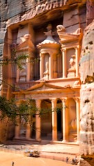 Fototapeta premium Ancient nabataean treasury carved into sandstone cliff in petra jordan