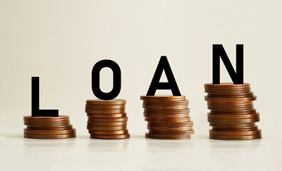 Word LOAN on step stack coins as graph up as business and financial concept. Interest and fees from...