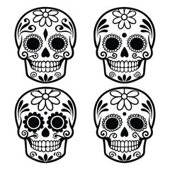 Four decorative sugar skulls with floral patterns for day of the dead celebration