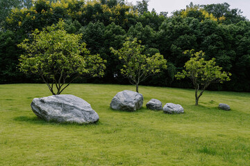 Summer Park View with Green Lawn, Large Rocks, and Trees – Serene Landscape with Distant Foliage © Sopear