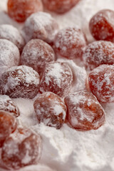 dried kumquat and powdered sugar, sweet dried orange kumquat fruits in white powdered sugar