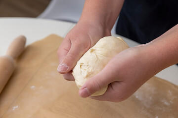 mix the wheat dough with your hands, hold the wheat yeast dough in your hands for making buns or tortillas or other baked goods