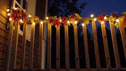 Cozy autumn evening: warm lights adorn rustic wooden balcony against dusk sky - Powered by Adobe