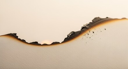 Burnt paper edge detail with visible ash and charred texture