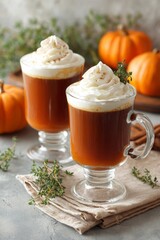 Pumpkin spice coffee with whipped cream in glass mugs on rustic autumn background. Pumpkin spice recipes, cozy fall concept