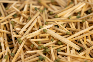 matches in a large pile, a large number of thin wooden matches with a head