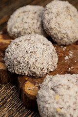 whole half sweet marshmallows in chocolate sprinkled with coconut chips, sweet dessert marshmallows in milk chocolate with coconut