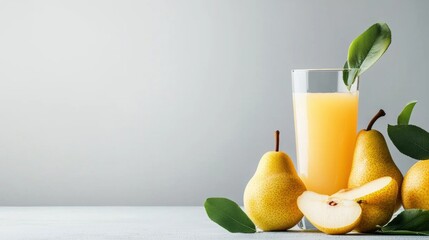 Fototapeta premium Glass of orange juice with a few whole pears and a slice of pear on the side. the glass is filled to the brim with the bright orange juice and has a few green leaves floating on top.
