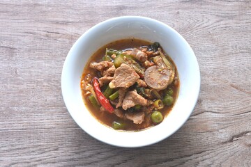 spicy boiled pork with mixed vegetable in jungle curry soup Thai food in bowl