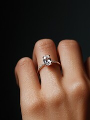 Obraz premium Close-up of a person's hand with a ring on their ring finger. the ring is made of rose gold and has a large, oval-shaped diamond in the center.