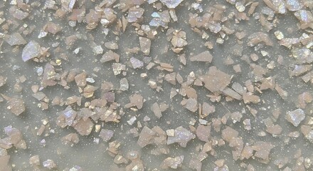 Close up image of muscovite mica flakes on a dark surface