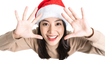 Playful Young Woman in Santa Hat with Hands Framing Face, Top-Down PNG