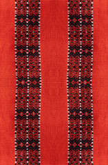 a textured fabric featuring intricate, floral embroidery. The overall style is traditional and ornate, a textured fabric showcasing a detailed,  woven pattern