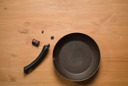 Broken Pan Handle on Wooden Table