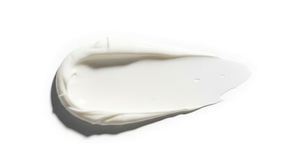A creamy white smudge with thick textured swirls transitions into a thinner liquid spread with tiny drops on a clean white surface casting a soft shadow