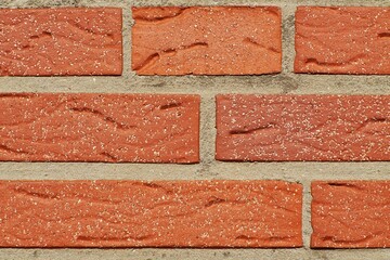 Obraz premium Red brick facade wall texture with weathered surface and mortar joints