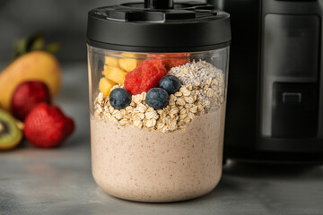 Healthy blend of fruits and oats in a kitchen mixer ready for a nutritious smoothie preparation