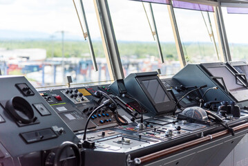 View of the control console on the navigational bridge of the cargo container ship.