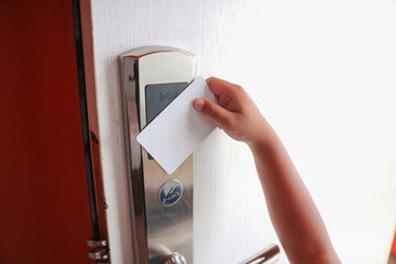 Ease of use. Children's hand touch keycard on hotel door