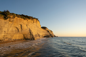 Golden Cliffs and Waves at Sunset Coastline