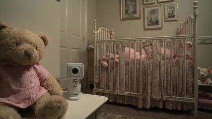 Cozy nursery scene featuring a teddy bear, a crib, and a small camera on a bedside table, capturing a sense of warmth and safety.