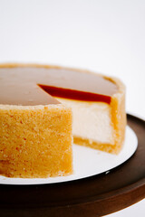 Delicious creamy dessert with caramel topping on a wooden serving platter