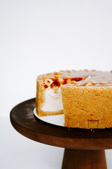 Delicious homemade cake on a wooden stand with a slice missing for tasting joy