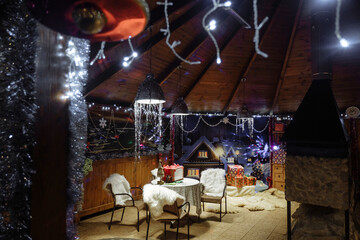 Cozy Christmas scene with decorations and lights.