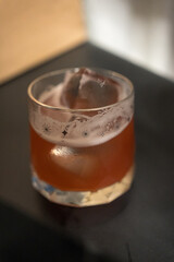 A glass of fresh fruit beer with ice. Close up