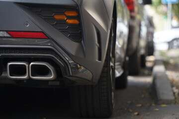 The exhaust pipe of the car. Ecology and traffic on one of the streets of the city.