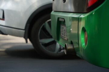 The exhaust pipe of a city bus. Ecology and traffic on one of the streets of the city.