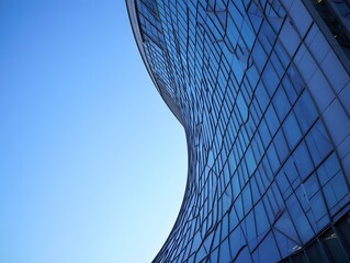 Abstract Architecture Detail - Curved Glass Facade Against Blue Sky