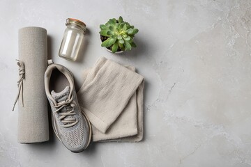 Fresh Morning Routine Flat Lay: Smoothie Jar, Yoga Mat, Sports Shoes, Linen Towel, and Succulent on Light Gray Marble Background.