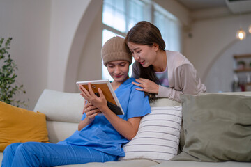 Cancer patient is receiving moral support from her friend at home.