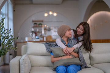 Cancer patient is receiving moral support from her friend at home.