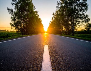 Empty road leading to a sunset