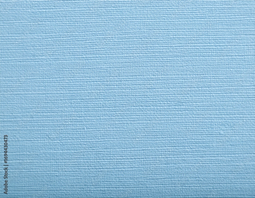 Poster close up of pale blue textured paper with fine embossed linen pattern for stationery and design proj
